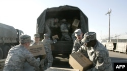 U.S. troops unload humanitarian aid at the air base in Manas on November 25.