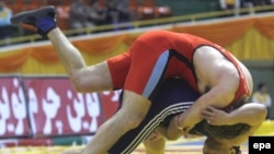 Rasul Tavakoli (bottom) of Iran fights American Michael Tamillow during their 96kg men's wrestling match in Tehran.