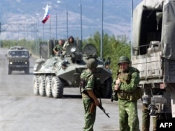 A Russian Army vehicle passes a checkpoint at the entrance of the flashpoint city of Gori, on August 18, 2008.