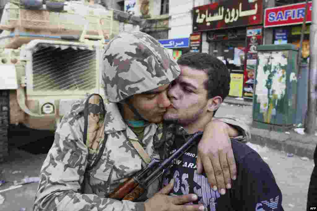 An Egyptian civilian kisses an army soldier after troops took position at major junctions in central Cairo on January 29, 2011.