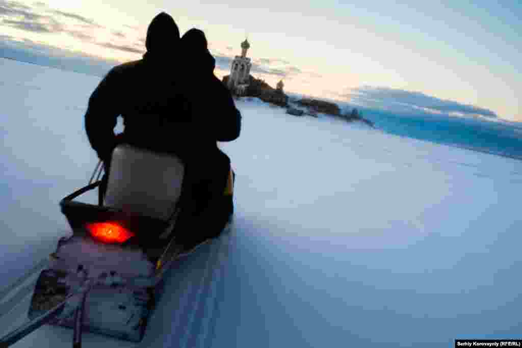 The churchwarden, Ivan, rides with Kirill to Spaso-Kamenny, about 10 km from the bank of Kybenskoe lake. During the winter the island is accessible by snowmobile or skis. It is possible to walk on the frozen lake surface by foot, but the journey can take three or four hours. In summer, locals use boats. A few weeks each year, the church is inaccessible when there is ice on the lake, but it is too thin for walking. In that case, a caretaker remains alone at the monastery.