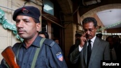 Karachi's new mayor Waseem Akhtar (right) cast his ballot in the mayoral election under police escort. 