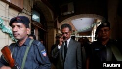 Karachi's new mayor Waseem Akhtar (right) cast his ballot in the mayoral election under police escort.
