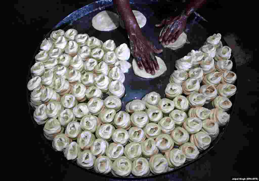 An Indian worker prepares material used for the making of vermicelli for the upcoming Hindu festival Karva Chauth in the village of Taroree, about 30 kilometers from Jammu, the winter capital of Kashmir. Karva Chauth is observed by married Hindu women who eat the traditionally prepared vermicelli in the wee hours of the morning and fast until dusk, praying for wedded bliss and a long life for their husbands. (EPA-EFE/Jaipal Singh)
