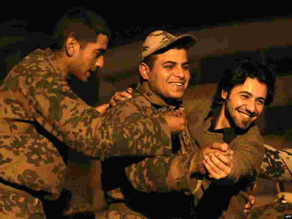 An antigovernment protester dances with a soldier during celebrations in Cairo's Tahrir Square on February 11.