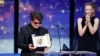 Iranian filmmaker Jafar Panahi holds the Palme d'Or at Cannes after receiving the prestigious award from actress Cate Blanchett on May 24.