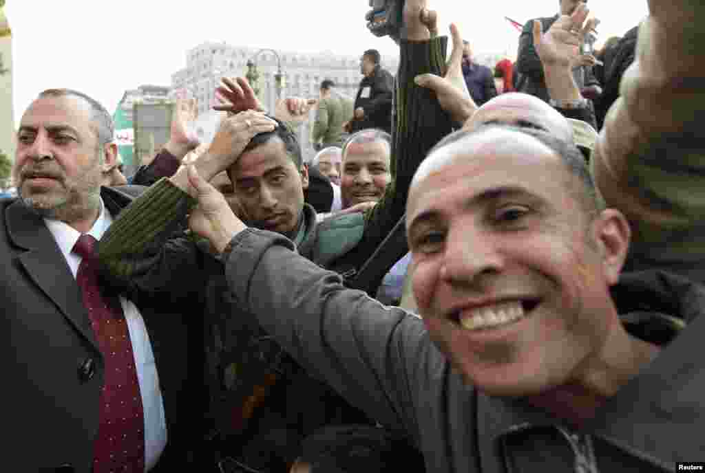 An Egyptian soldier is mobbed by celebrating protesters in Tahrir Square on February 10, 2011.
