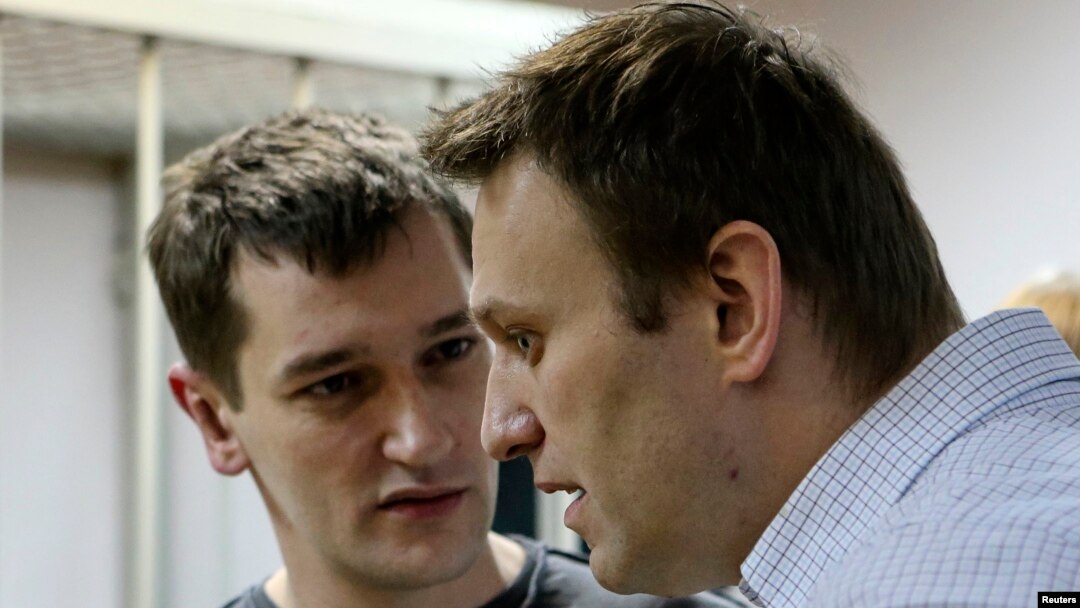 Russian opposition leader and anticorruption blogger Aleksei Navalny (front) and his brother and co-defendant Oleg attend a court hearing in Moscow on December 30.