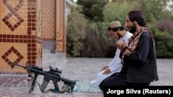 A Taliban fighter prays at the Abdul Rahman Mosque in Kabul on October 4.