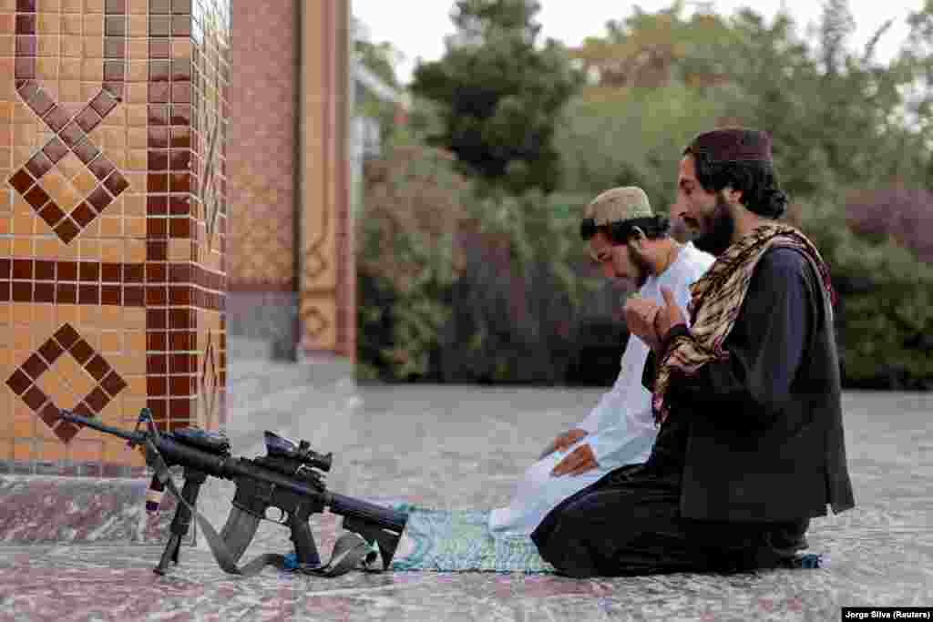 A Taliban fighter prays at the Abdul Rahman Mosque in Kabul.