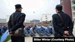 Guards monitor Uyghur inmates at a reeducation camp in northwestern China's Xinjiang region. (file photo)