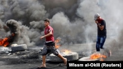 Demonstrators defy a curfew, two days after the nationwide anti-government protests turned violent, in Baghdad, October 3, 2019.