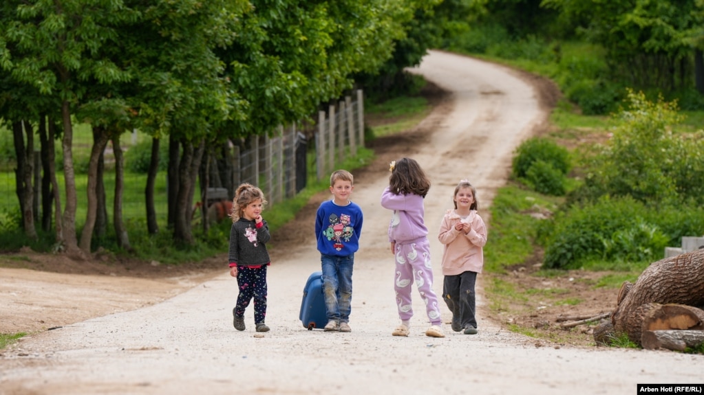Disa fëmijë duke shëtitur në një rrugë të fshatit Brus, në pjesën qendrore të Kosovës. Ky fshat njihet si një vend ku katolikët dhe myslimanët janë një familje.
