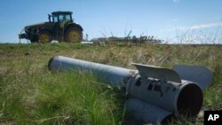 Трактор минава край фрагмент от руска ракета в Изюм, Харковска област, 20 април 2024 г.