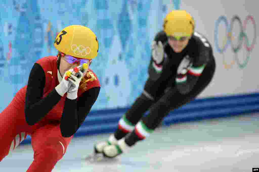 China&#39;s Zhou Yang celebrates after winning the gold medal in the women&#39;s short track 1.500m final. 