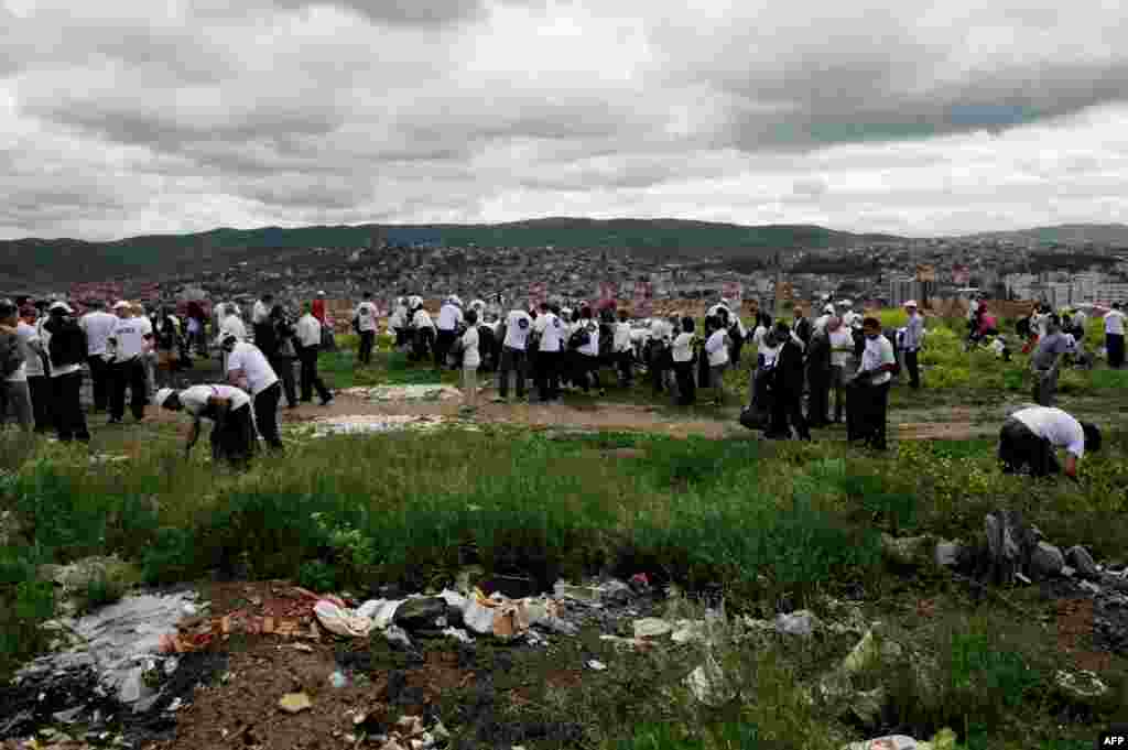 Volunteers remove garbage during a cleaning operation in Pristina, Kosovo. In 2012, more than 80,000 people removed 10,000 tons of garbage in a day. (AFP/Armend Nimani)