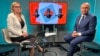 Interim Romanian President Ilie Bolojan (right) at the Bucharest office of RFE/RL on May 12 for an interview ahead of this weekend's runoff election between ultranationalist politician George Simion and pro-Western reformist Nicusor Dan.