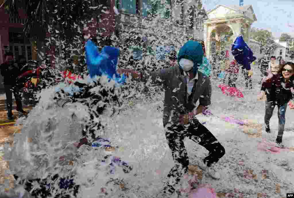 People engage in a pillow-fight game in Changsha, China, to celebrate ahead of International Women's Day. (AFP)