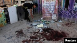 A boy inspects the site of a deadly bomb attack in Baghdad on July 31.