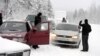 Asylum seekers wait to cross the border between Finland and Russia at Salla, on the Russian side of the border, on January 23.