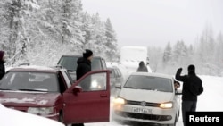 Asylum seekers wait to cross the border between Finland and Russia at Salla, on the Russian side of the border, on January 23.