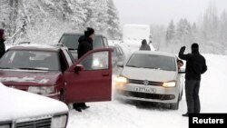 Asylum seekers wait to cross the border between Finland and Russia at Salla, on the Russian side of the border, on January 23.