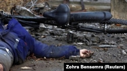 The body of a woman who witnesses said was shot and killed by Russian soldiers lies on the street in Bucha on April 2.