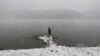 A man fishes during a heavy snowfall on the banks of the Yenisei River outside Krasnoyarsk, Russia. (Reuters/​Ilya Naymushin)