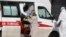 Medical workers wearing protective clothing take a suspected COVID-19 patient into quarantine. One Russian NGO says it's been contacted by many people in quarantine who feel abandoned without information.