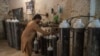 A worker fills oxygen cylinders for hospital use in Peshawar on December 7.