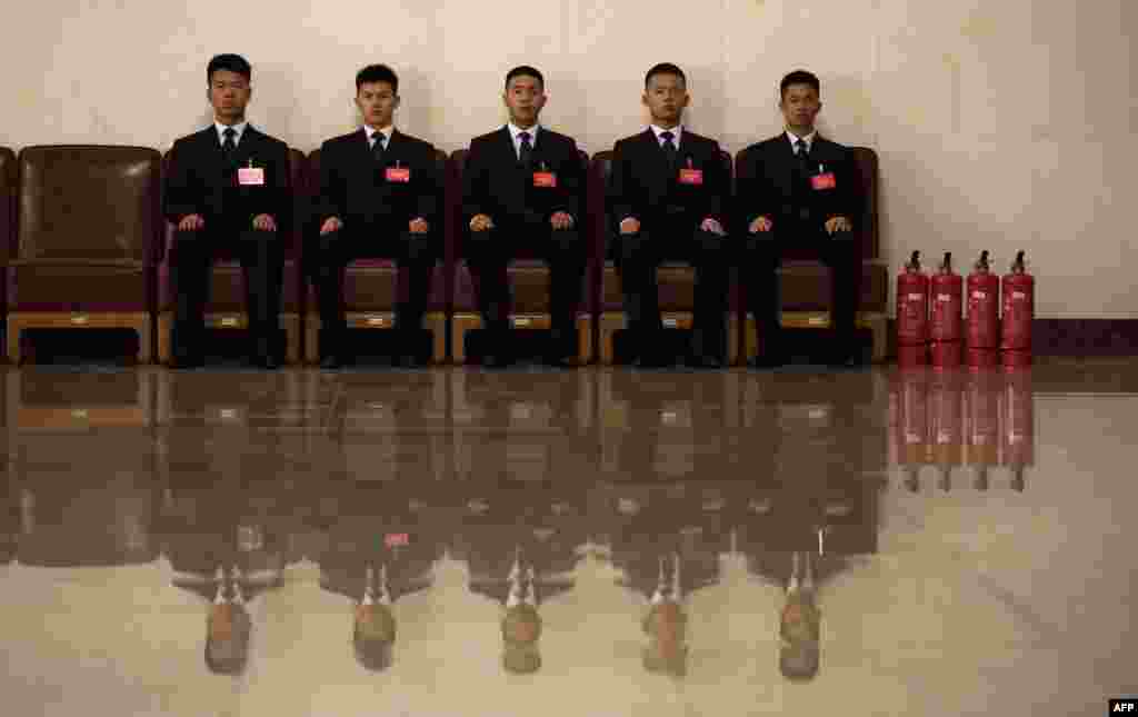 Security guards sit outside the Great Hall of the People ahead of the opening session of the Fourth Session of the 12th National Committee of the Chinese People's Political Consultative Conference (CPPCC) in Beijing on March 3. (AFP/Johannes Eisele)