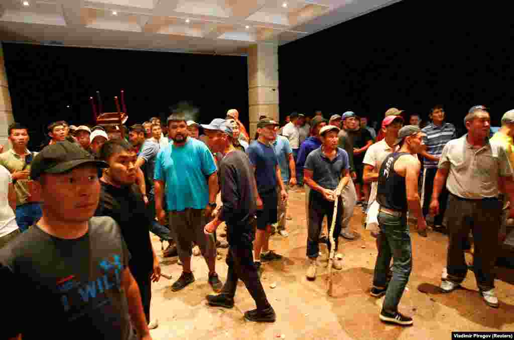 Supporters gather at the entrance to a building in the compound.&nbsp;