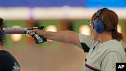 Nino Salukvadze competes in the 10-meter women's air pistol event at her final Olympic Games in Paris on July 27. 