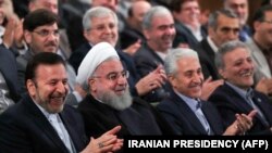 IRAN -- A handout picture provided by the office of Iranian President Hassan Rohani on October 14, 2018 shows him (Second Left) attending a ceremony at Tehran University marking the beginning of the new Iranian academic year. 