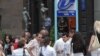 Armenia -- Bank employees anxiously wait outside their offices following an earthquake that struck Yerevan and surrounding areas on June 18, 2009.