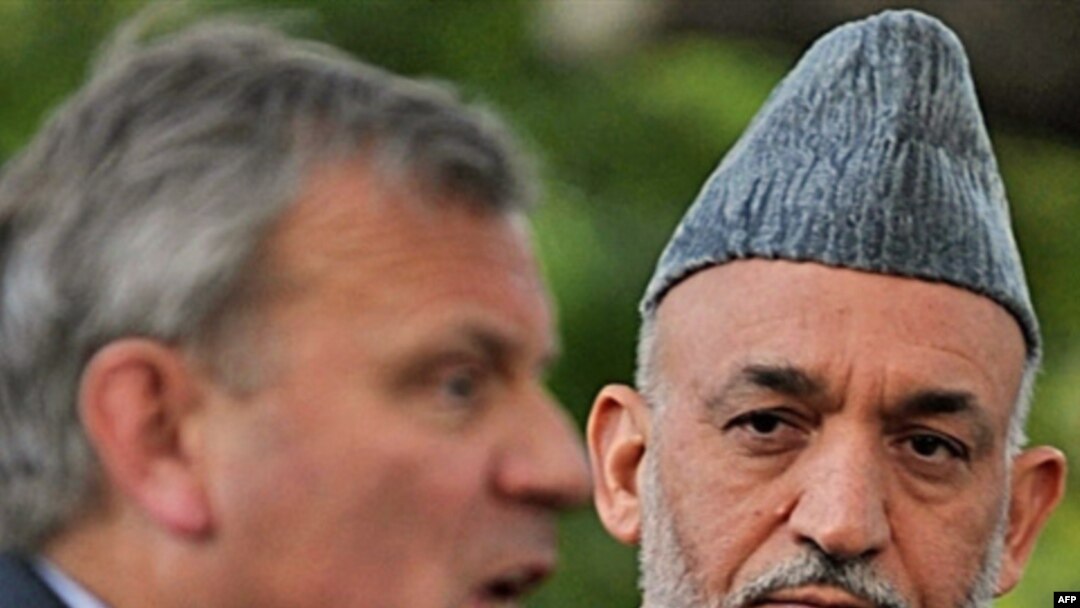 President Karzai (right, with NATO Secretary-General Jaap de Hoop Scheffer) faces intense public pressure over civilian killings