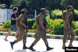Pakistani soldiers patrol near the presidential residence in Islamabad on April 19.