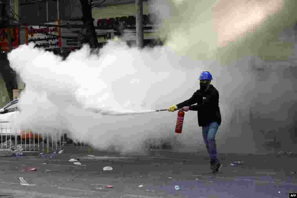 A protester lets off a fire extinguisher during a demonstration against the military coup in Yangon on March 2, 2021.