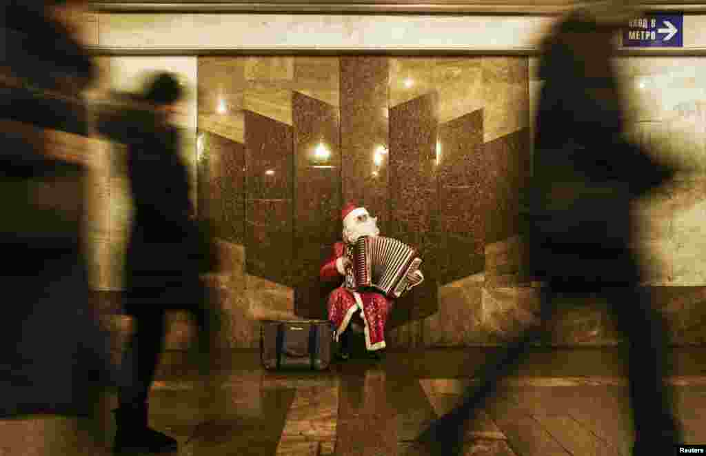 A man dressed as Father Frost, the Russian equivalent of Santa Claus, plays accordion at an underground crossing in Moscow. (Reuters/Maxim Shemetov)