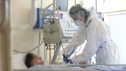 Armenia -- A healthcare worker in protective gear tends to a COVID-19 patient at the Surp Grigor Lusavorich Medical Center, Yerevan, June 5, 2020.