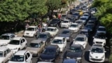 Vehicles wait in traffic as residents flee Tehran on June 15.