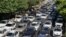 Vehicles wait in traffic as residents flee Tehran on June 15.