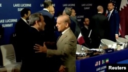Pakistani Prime Minister Shehbaz Sharif (right) welcomes Iranian Foreign Minister Abbas Araqchi, as US Vice President JD Vance stands in the background, before the start of peace talks in Switzerland on June 21.