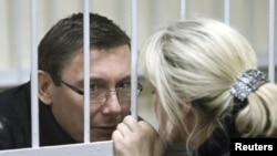 Former Interior Minister Yuriy Lutsenko talks with his wife, Irina, before the start of a court session in Kyiv on December 27.