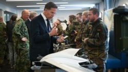 NATO Secretary-General Mark Rutte (L) inspects a Lockheed Martin Sentinel reconnaissance drone at the German-Netherlands Corps in Muenster on October 1.