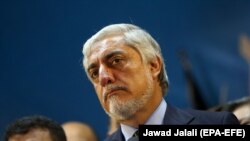 Afghan presidential candidate Abdullah Abdullah talks with journalists during a press conference in Kabul, on September 30.