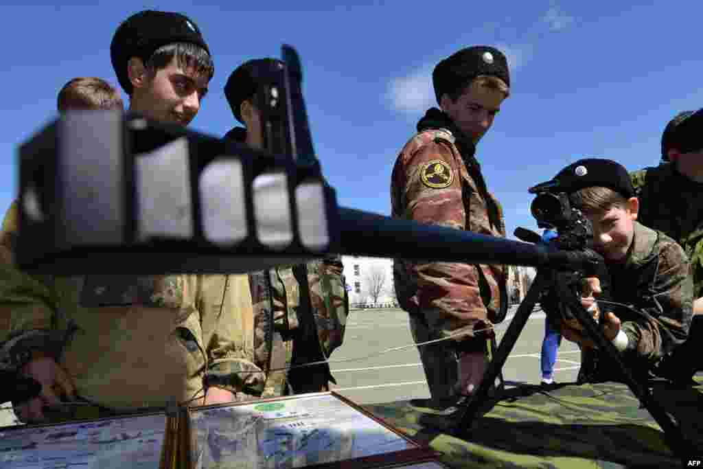 Cadets of the General Aleksei Yermolov Cossack School examine a weapon during the Day of Conscript in Stavropol, &nbsp;Russia. (AFP/Danil Semyonov)