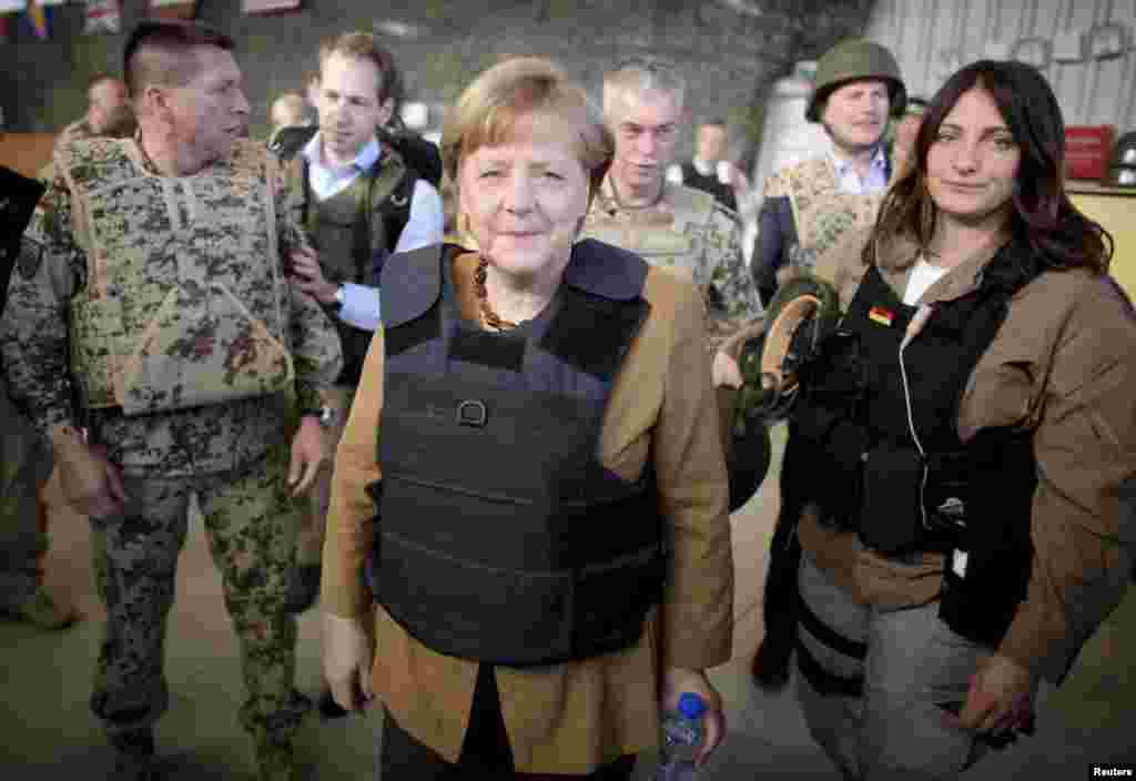 Chancellor Angela Merkel sports a flak jacket after arriving in the Afghan city of Mazar-e Sharif in May 2013 to meet with German soldiers.