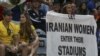 An Iranian activist, Darya Safai holds a banner reading "Let Iranian women enter their stadiums" at the Iranian men's volleyball match against Egypt in the 2016 Olympics.
