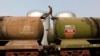 A worker walks atop a tanker wagon to check the freight level at an oil terminal on the outskirts of Kolkata. File photo